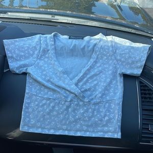 Brandy Melville  light blue crossover top with white flower details